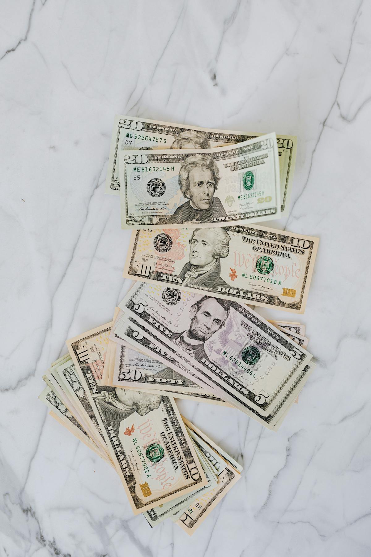 Stack of US dollar bills representing compounding pay raise versus one-time bonus compensation decisions