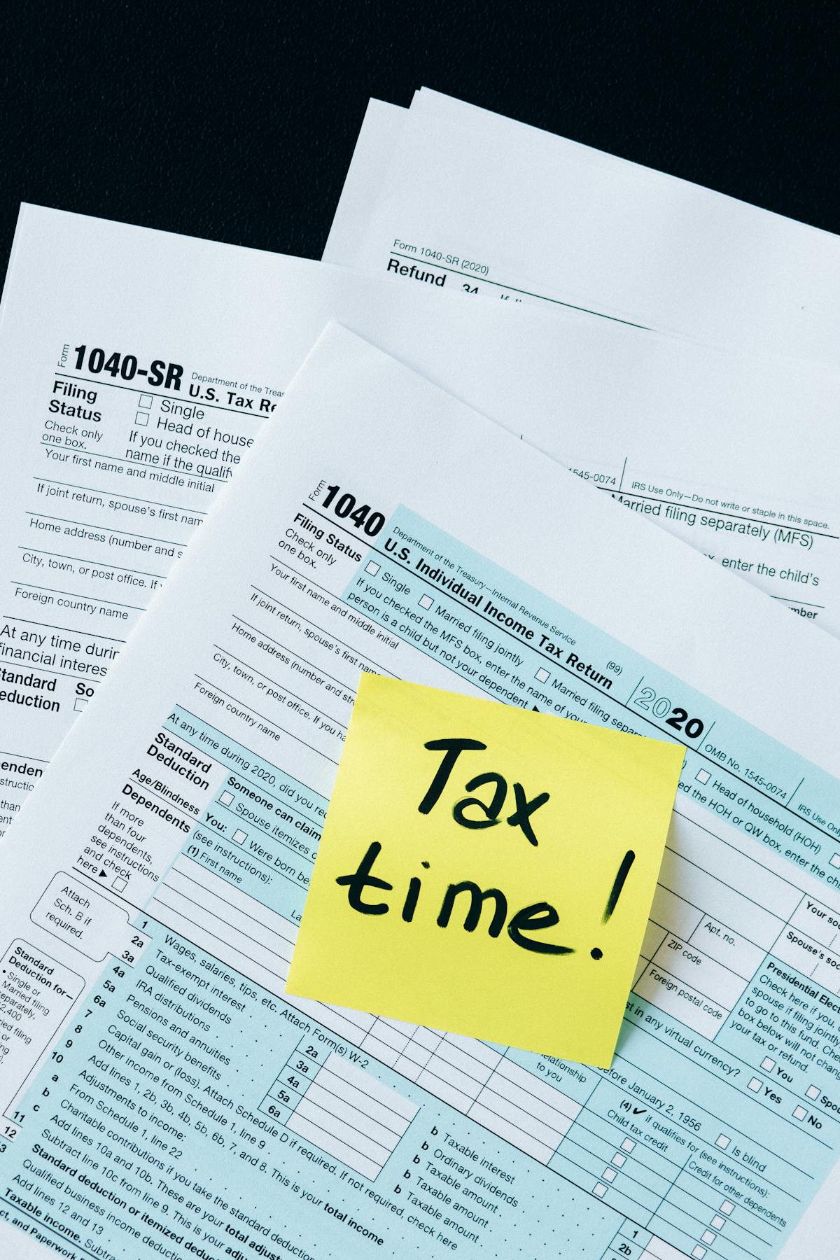 State income tax forms and paperwork on a desk showing W2 and filing documents